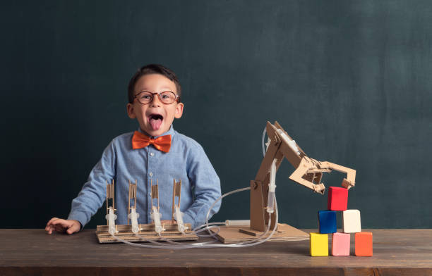 istock Cute child invented robot arm with cardboard. 821164804
