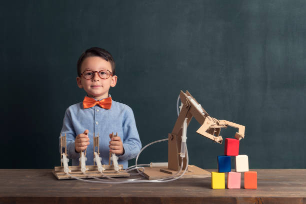 istock Cute child invented robot arm with cardboard. 821164998
