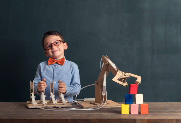istock Cute child invented robot arm with cardboard. 821165154