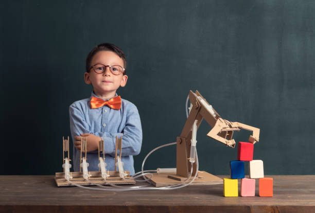 istock Cute child invented robot arm with cardboard. 821165208