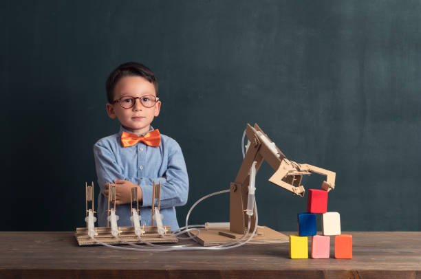 istock Cute child invented robot arm with cardboard. 821165390