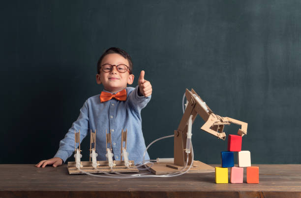 istock Cute child invented robot arm with cardboard. 821165470