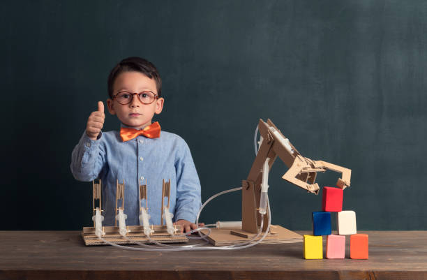 istock Cute child invented robot arm with cardboard. 821165496