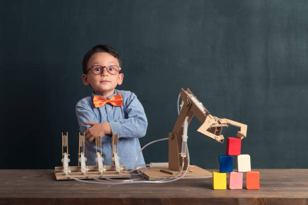 istock Cute child invented robot arm with cardboard. 821165854