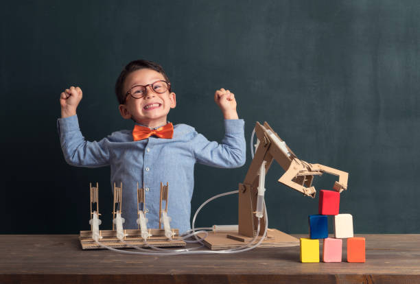 istock Cute child invented robot arm with cardboard. 821165874