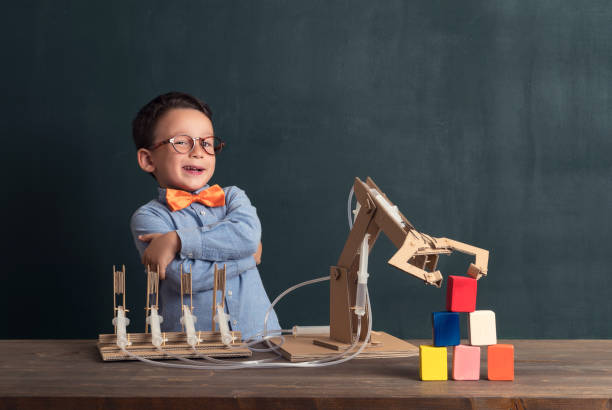istock Cute child invented robot arm with cardboard. 821166016
