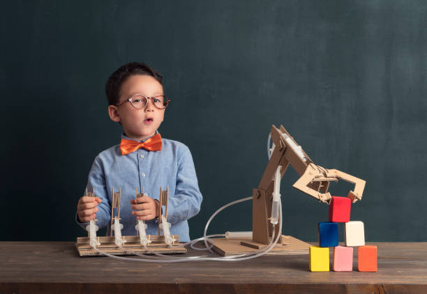 istock Cute child invented robot arm with cardboard. 821168456