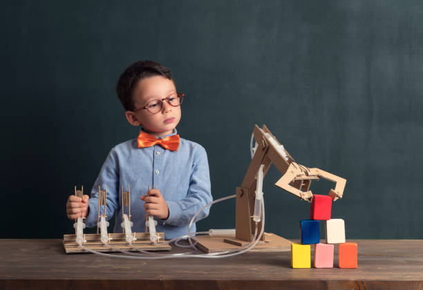 istock Cute child invented robot arm with cardboard. 821168558