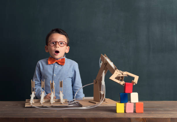 istock Cute child invented robot arm with cardboard. 821168804