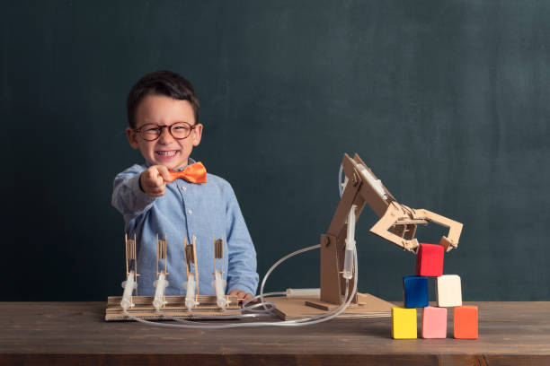 istock Cute child invented robot arm with cardboard. 821168912