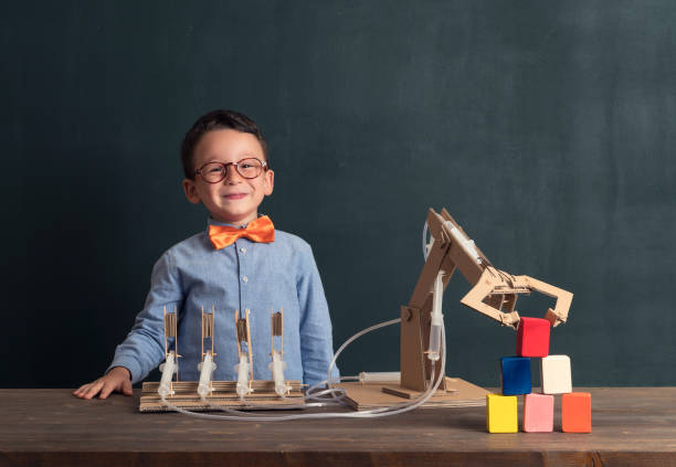 istock Cute child invented robot arm with cardboard. 821168928