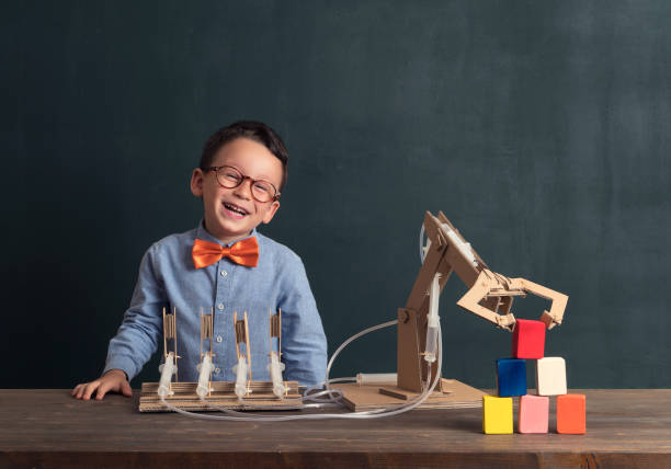 istock Cute child invented robot arm with cardboard. 821169030