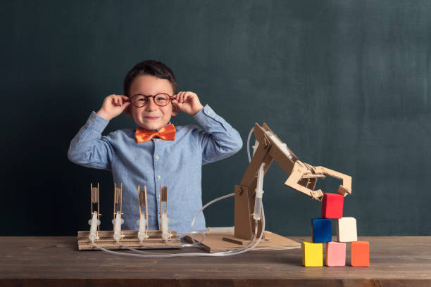 istock Cute child invented robot arm with cardboard. 821169244