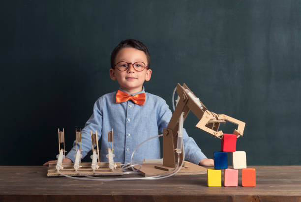 istock Cute child invented robot arm with cardboard. 821169246