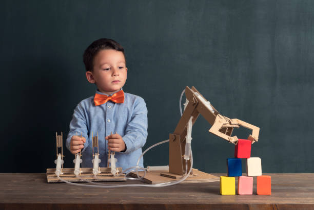 istock Cute child invented robot arm with cardboard. 821169248