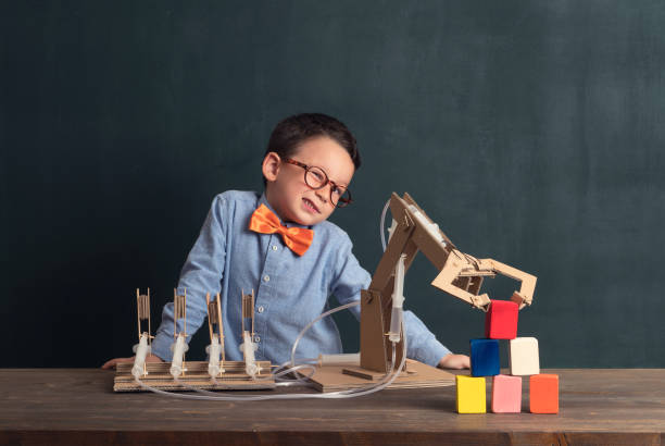 istock Cute child invented robot arm with cardboard. 821169312