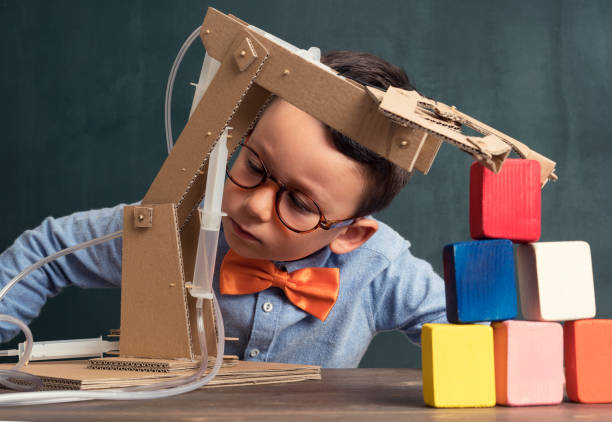 istock Cute child invented robot arm with cardboard. 821169566