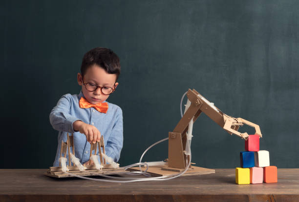 istock Cute child invented robot arm with cardboard. 821169606