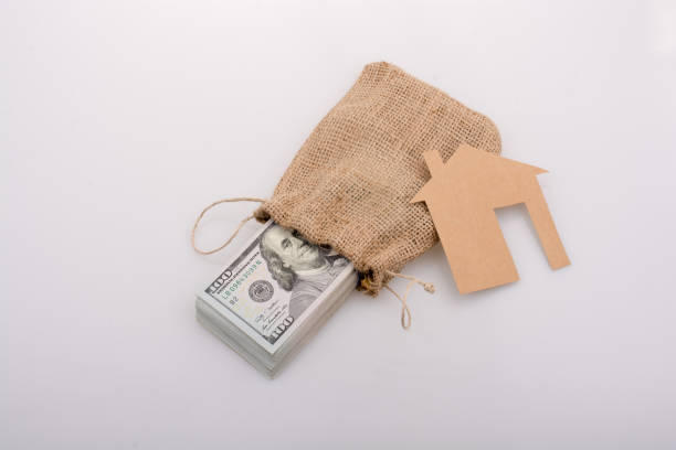 istock Paper house beside US dollar banknote 821169612