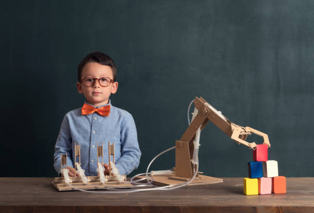 istock Cute child invented robot arm with cardboard. 821169630