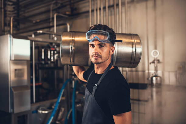 istock Brewer with keg at brewery factory 821169760