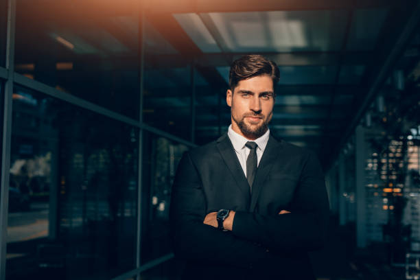 istock Handsome young businessman standing with his arms crossed 821172580
