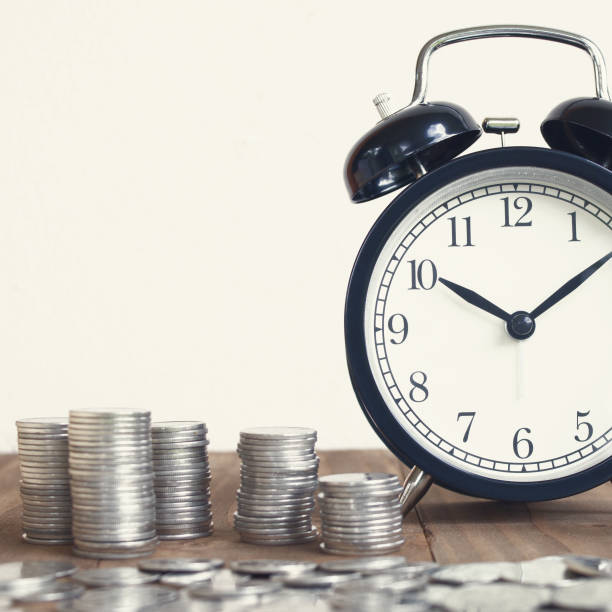 istock Stack Of Coins With Black Fashioned Alarm Clock For Display Planning Money Financial And Business Accounting Concept, Time Is Money Concept, Time To Work At Make Money, Vintage Color Tone 821173768