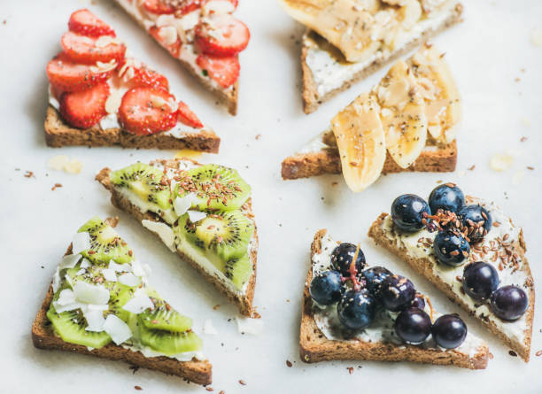 istock Healthy breakfast wholegrain bread toasts with cream-cheese, fruit, seeds, nuts 821180834