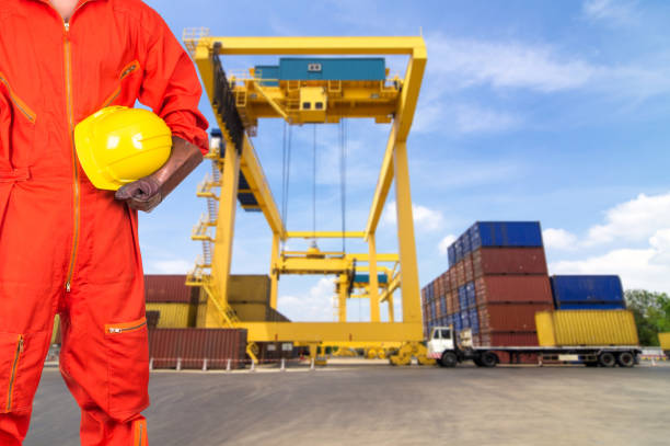 istock Asian engineers holding a yellow hardhat on Under construction four cranes with cloud on blue sky, constructure industrial concept 821181408