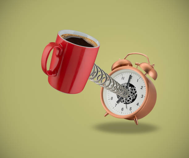 Red coffee mug springing out of alarm clock stock photo