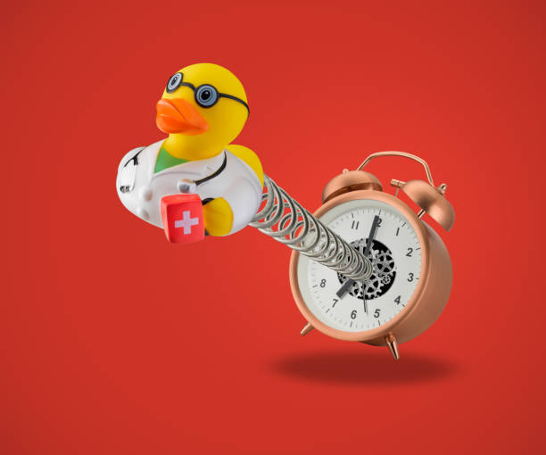 Photo of Rubber duck doctor coming out of alarm clock on spring
