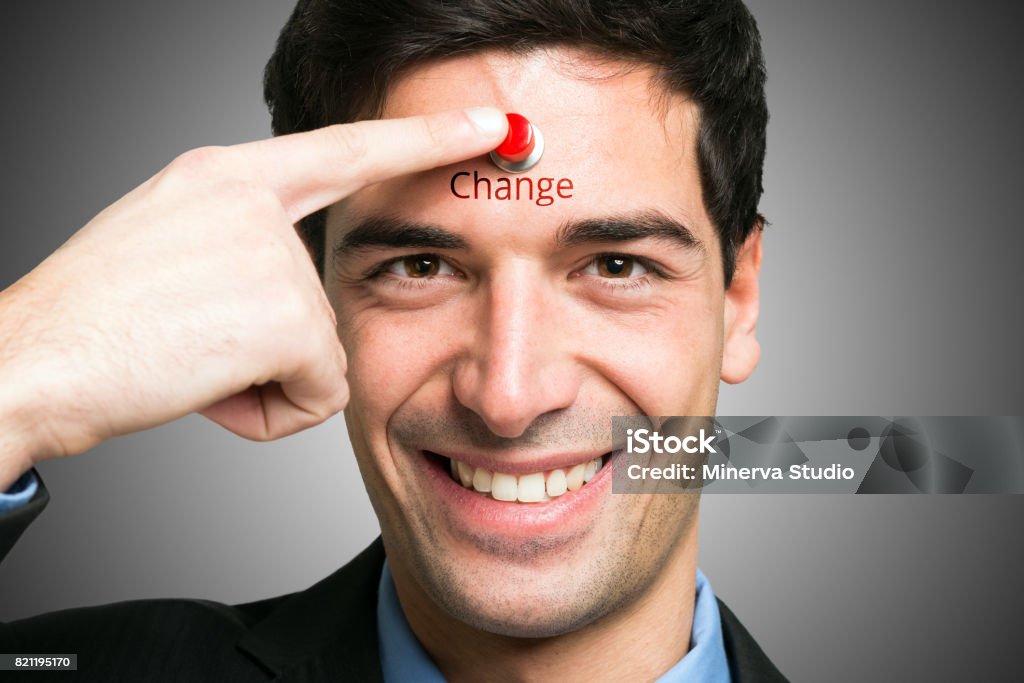 Change yourself concept, man pressing a button on his forehead Change yourself Change Stock Photo