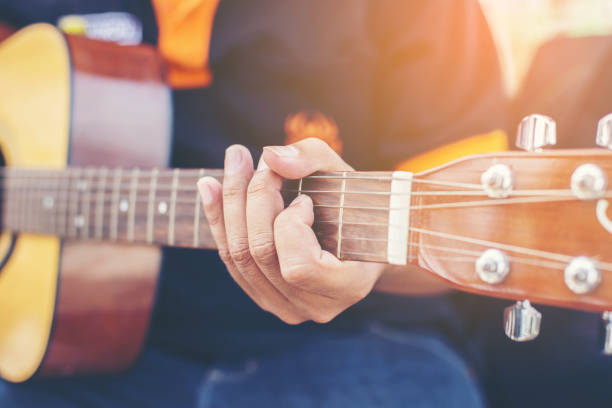 istock Close up of man hand playing guitar 821198818