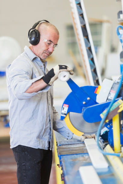 istock Man sawing wood in shutter factory 821202124