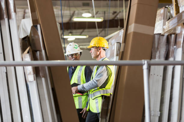 istock Two men in a warehouse of construction supplies talking 821202550