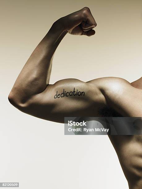 Arm With Word Written On Bicep Stock Photo - Download Image Now - Bicep, Flexing Muscles, 25-29 Years