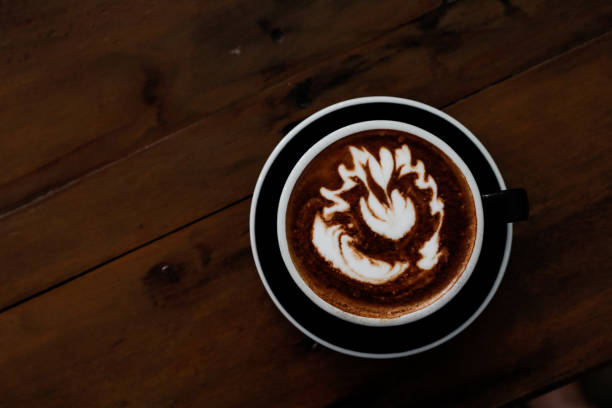 istock Coffee cup in coffee shop on wooden table. 821205402