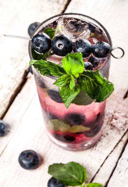 istock Summer cold drink with blueberry, mint and ice in glass on white background 821212768