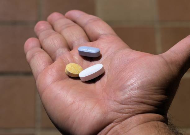 istock Palm of hand with three drug pills 821213480