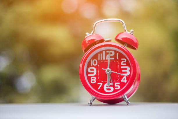 istock 6 o'clock Clock Vintage on Wood Table with Sun Light 821214582