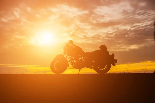Photo of biker over sunset