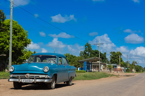 Blue american vintage car parked on the side from the Main Street to Santa Clara - Serie Cuba Reportage