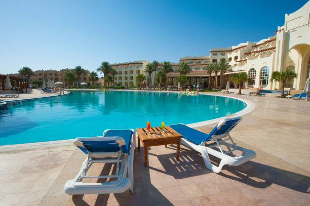 istock Large swimming pool at luxury tropical hotel 821225734