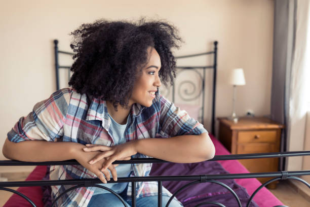 istock Beautiful african woman on bed 821225762