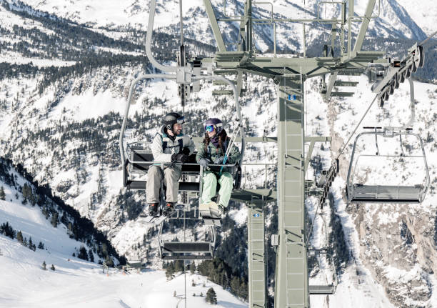 istock Woman and man using skiing lift 821230894