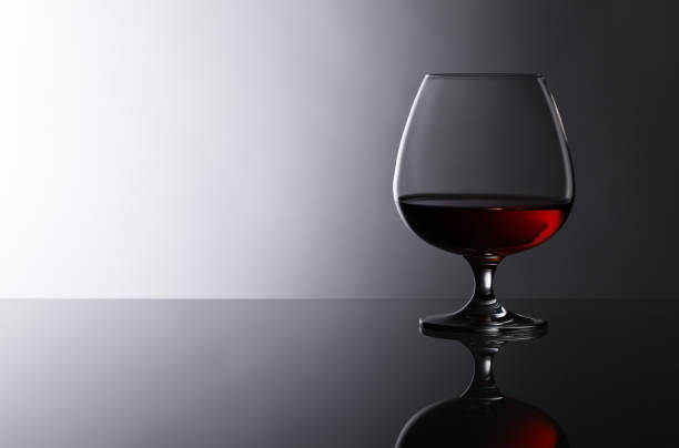 istock snifter of brandy on glass table 821235064