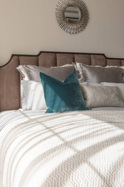 istock classic bedroom style with set of pillows and lamp on table side 821235360