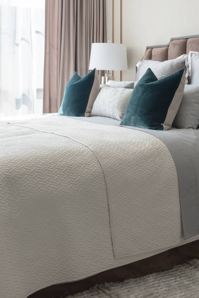 istock classic bedroom style with set of pillows and lamp on table side 821235376