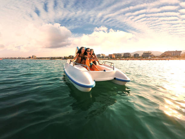 istock Three young women on pedal boat enjoy summer 821239004