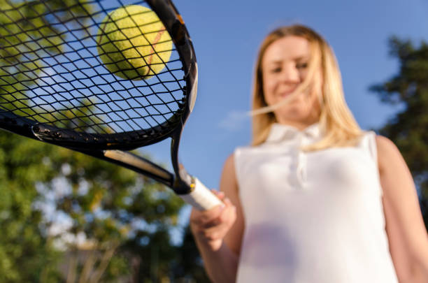 istock Bottom view of tennis ball on racket 821254878